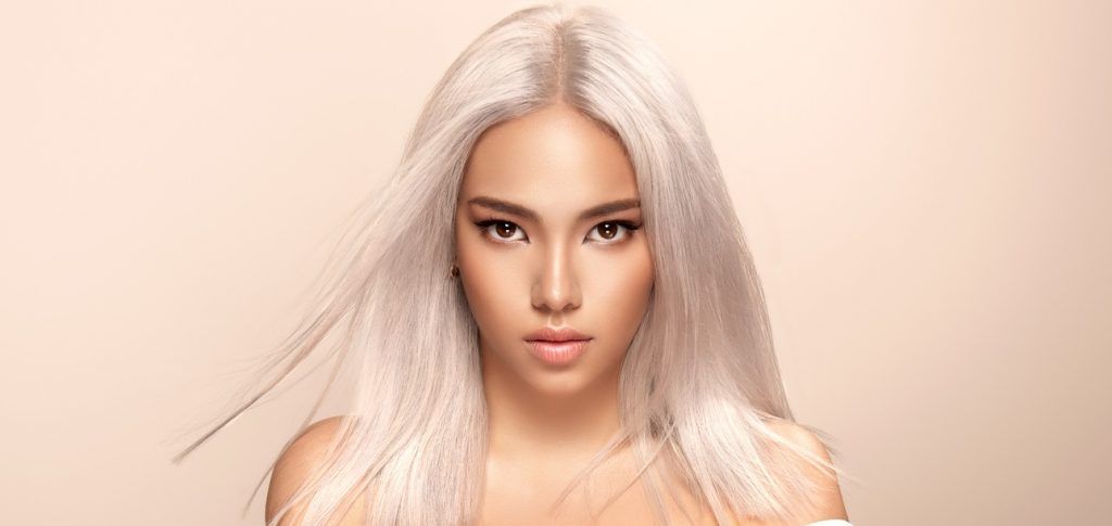 Woman with toned hair after getting professional hair dye in Denver